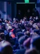 Large audience seated in an indoor arena during an event
