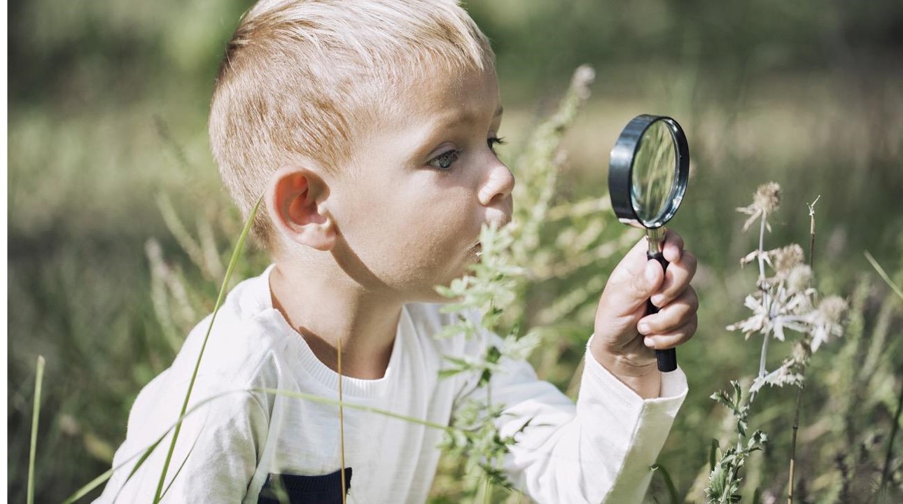 Boy with magnifying glass