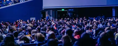 Large audience seated in an indoor arena during an event